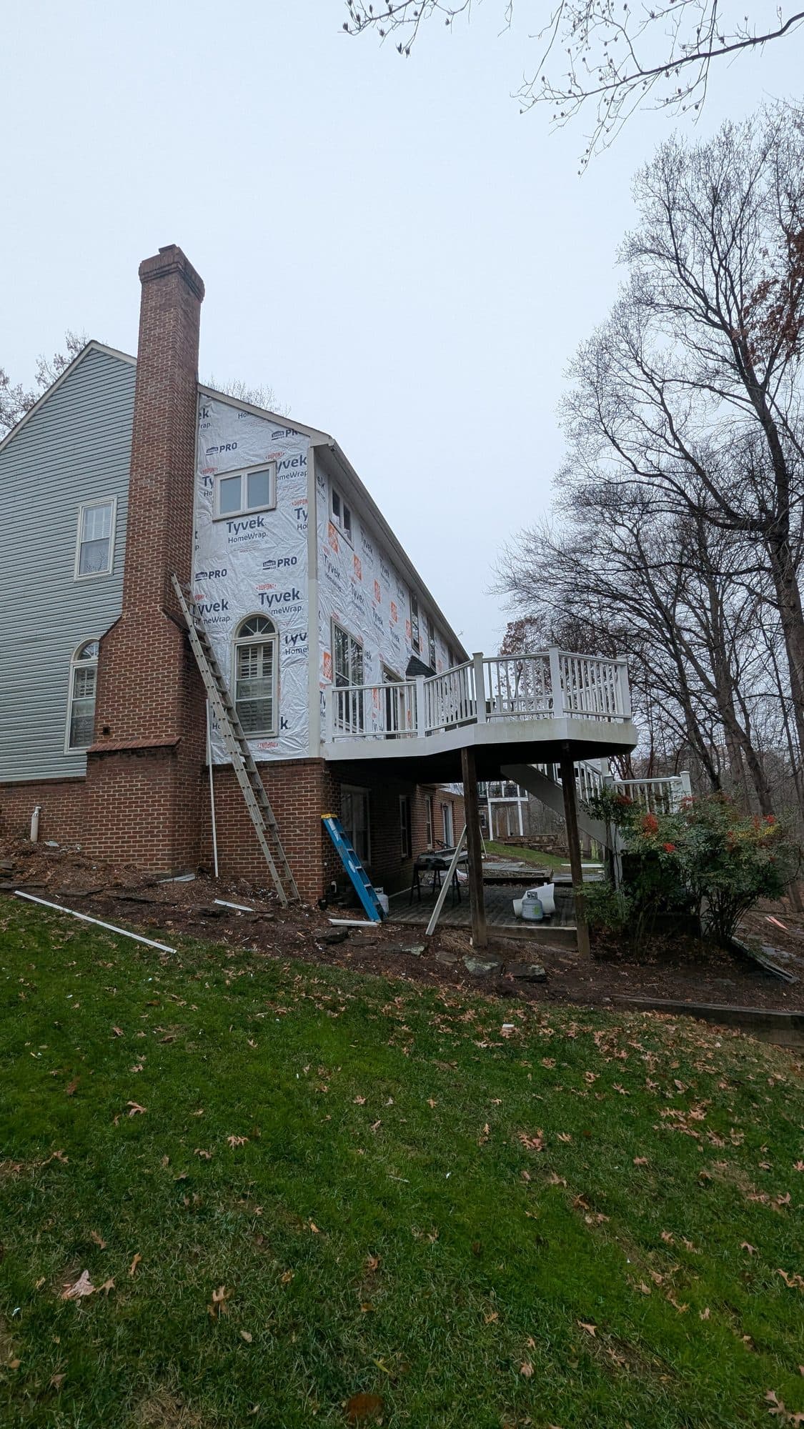 Home wrapped in house wrap along the rear elevation, prepped for new siding installation